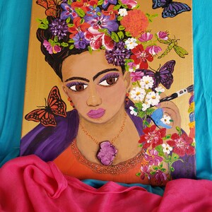 May include: A painting of a woman with a crown of flowers on her head. She is wearing a purple shawl and a necklace with a large purple stone. The background is gold and there are butterflies and dragonflies painted around her.