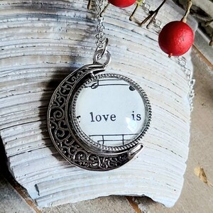 Love is Forever crescent moon rotating glass pendant vintage book page