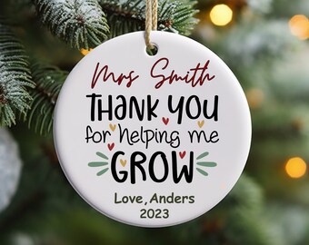 May include: White ceramic Christmas ornament with the text "Mrs. Smith Thank You for Helping Me GROW Love, Anders 2023".