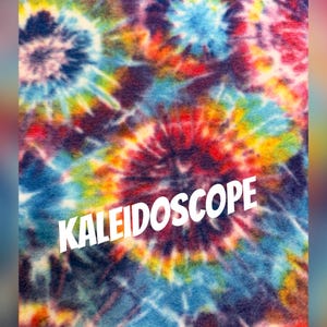 May include: A vibrant, colorful textile with a tie-dye pattern. The design features concentric circles in shades of blue, red, yellow, and purple. The word "KALEIDOSCOPE" is prominently displayed in white text across the fabric.