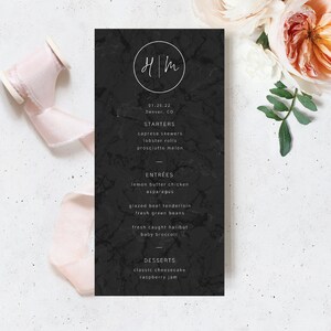 May include: Black and white wedding menu with a marble background. The menu lists starters, entrees, and desserts. The text (HM) is at the top of the menu.