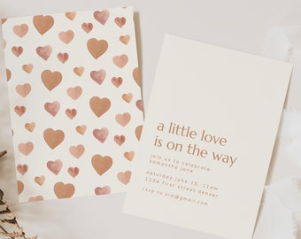 May include: A baby shower invitation with a watercolor heart pattern on the left and text on the right that reads "a little love is on the way". The invitation includes the date, time, location, and RSVP information.