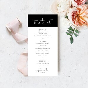 May include: A black and white wedding menu with the text "time to eat" in cursive. The menu lists starters, entrees, and desserts. The bottom of the menu includes the names "Stephen and Kim" and the date "01.25.22".
