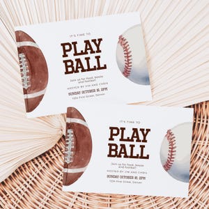 May include: Two white invitation cards with brown text that reads "It's time to play ball". The cards feature watercolor illustrations of a baseball and a football.