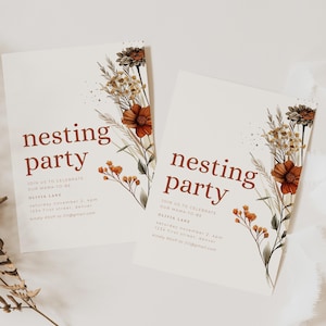May include: Two white nesting party invitations with floral illustrations in shades of orange, brown, and green. The text "nesting party" is in a warm brown color. Additional text includes event details and RSVP information.