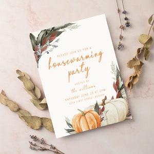 May include: Housewarming party invitation with orange text and floral accents. The invitation includes the text "PLEASE JOIN US FOR A housewarming party HOSTED BY the williams SATURDAY JUNE 15 AT 1PM 1234 FIRST STREET DENVER". The design features pumpkins.