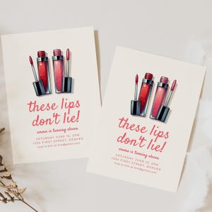 May include: Two invitation cards with a pink and white color scheme. The cards feature a graphic of three red and pink lip glosses with silver glitter. The text on the cards reads "these lips don't lie!" and "emma is turning eleven". The cards also include the date, time, and location of the event.