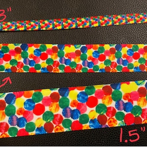 May include: Three different widths of colorful ribbon with a polka dot pattern. The ribbon is 3/8 inch, 1 inch, and 1.5 inches wide.