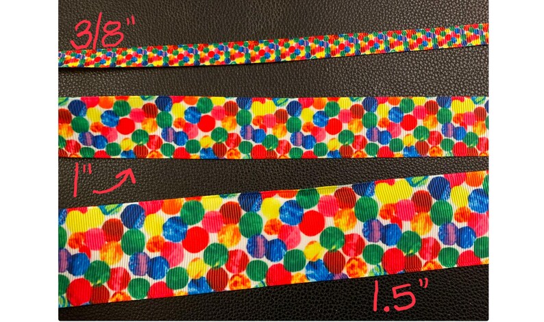 May include: Three different widths of colorful ribbon with a polka dot pattern. The ribbon is 3/8 inch, 1 inch, and 1.5 inches wide.