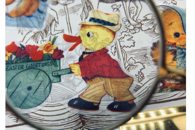 May include: A vintage Easter card featuring a yellow chick pushing a green wagon with flowers and the text "Easter Greetings". The chick is wearing a red jacket and a black and white hat.