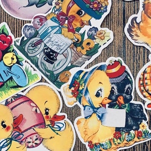 May include: A set of vintage Easter stickers featuring yellow chicks in various poses. Some chicks are holding flowers, riding a tricycle, or carrying an egg. Other stickers feature a black and white chick, a yellow chick with a plaid pattern, and a fluffy white kitten.