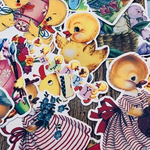 May include: A collection of vintage Easter stickers featuring yellow chicks, a bunny, and floral designs. The stickers are printed on white paper with a glossy finish.