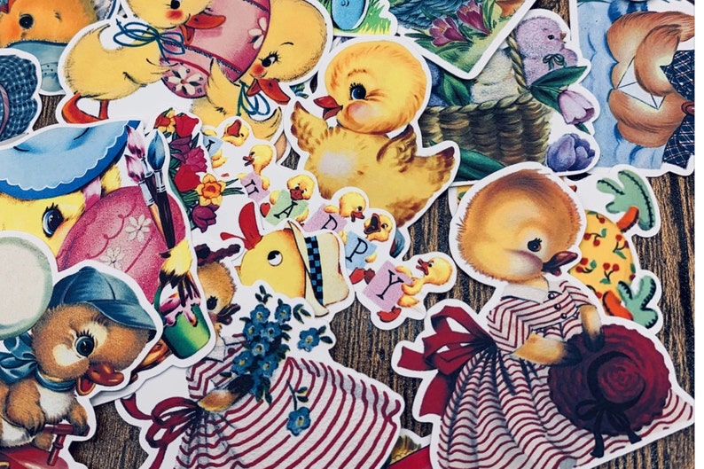 May include: A collection of vintage Easter stickers featuring yellow chicks, a bunny, and floral designs. The stickers are printed on white paper with a glossy finish.