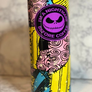 May include: A black and yellow tumbler with a purple and black circle design. The circle says "I'm a Nightmare Before Coffee".