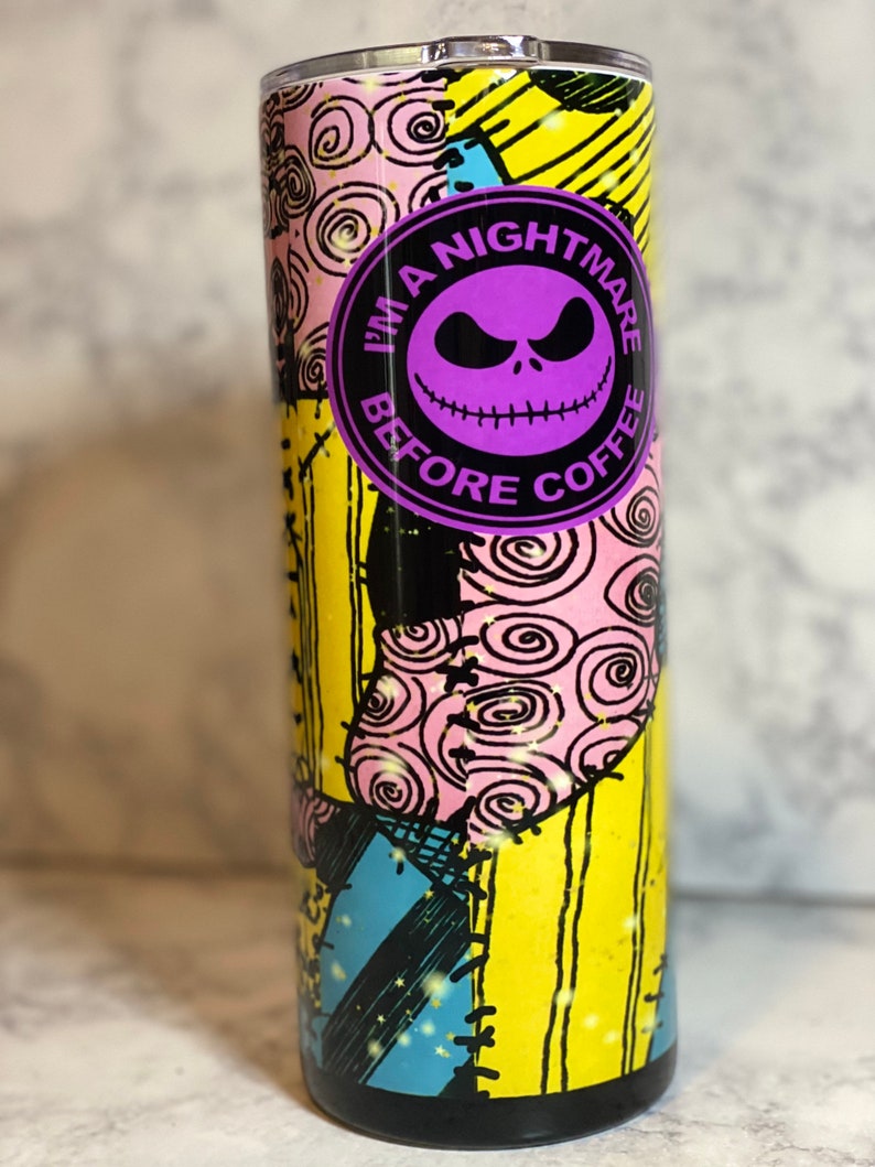 May include: A black and yellow tumbler with a purple and black circle design. The circle says "I'm a Nightmare Before Coffee".