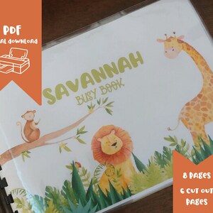 May include: A printable PDF busy book for children featuring a jungle theme. The cover features a giraffe, monkey, and lion with green foliage. The title of the book is "Savannah Busy Book" with the name "Savannah" in a green font. The book has 8 pages with 6 cut-out pages.