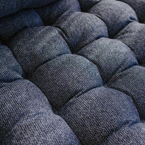 Dark blue outdoor cushion set on a bench, featuring a bottom seat cushion and matching backrest in French mattress style. Made from high-quality EU-produced bouclé-like fabric suitable for outdoor use. The material is water-repellent but not fully waterproof and can get wet occasionally. Also suitable for indoor spaces. Perfect for modern Scandinavian homes, A-frame houses, Portuguese terraces and bohemian Spanish villas.