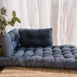 Dark blue outdoor cushion set on a bench, featuring a bottom seat cushion and matching backrest in French mattress style. Made from high-quality EU-produced bouclé-like fabric suitable for outdoor use. The material is water-repellent but not fully waterproof and can get wet occasionally. Also suitable for indoor spaces. Perfect for modern Scandinavian homes, A-frame houses, Portuguese terraces and bohemian Spanish villas.