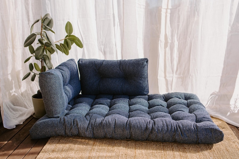 Dark blue outdoor cushion set on a bench, featuring a bottom seat cushion and matching backrest in French mattress style. Made from high-quality EU-produced bouclé-like fabric suitable for outdoor use. The material is water-repellent but not fully waterproof and can get wet occasionally. Also suitable for indoor spaces. Perfect for modern Scandinavian homes, A-frame houses, Portuguese terraces and bohemian Spanish villas.