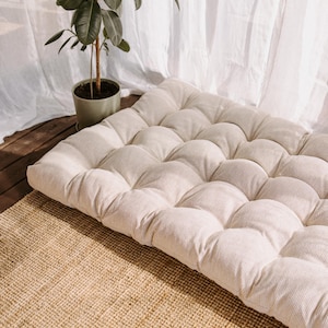 Boucle white outdoor cushion set on a bench, featuring a bottom seat cushion and matching backrest in French mattress style. Made from high-quality EU-produced bouclé-like fabric suitable for outdoor use. The material is water-repellent but not fully waterproof and can get wet occasionally. Also suitable for indoor spaces. Perfect for modern Scandinavian homes, A-frame houses, Portuguese terraces and bohemian Spanish villas.