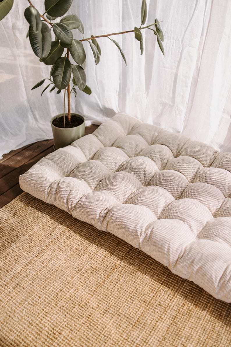 Boucle white outdoor cushion set on a bench, featuring a bottom seat cushion and matching backrest in French mattress style. Made from high-quality EU-produced bouclé-like fabric suitable for outdoor use. The material is water-repellent but not fully waterproof and can get wet occasionally. Also suitable for indoor spaces. Perfect for modern Scandinavian homes, A-frame houses, Portuguese terraces and bohemian Spanish villas.