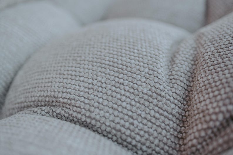Cream white outdoor cushion set on a bench, featuring a bottom seat cushion and matching backrest in French mattress style. Made from high-quality EU-produced bouclé-like fabric suitable for outdoor use. The material is water-repellent but not fully waterproof and can get wet occasionally. Also suitable for indoor spaces. Perfect for modern Scandinavian homes, A-frame houses, Portuguese terraces and bohemian Spanish villas.