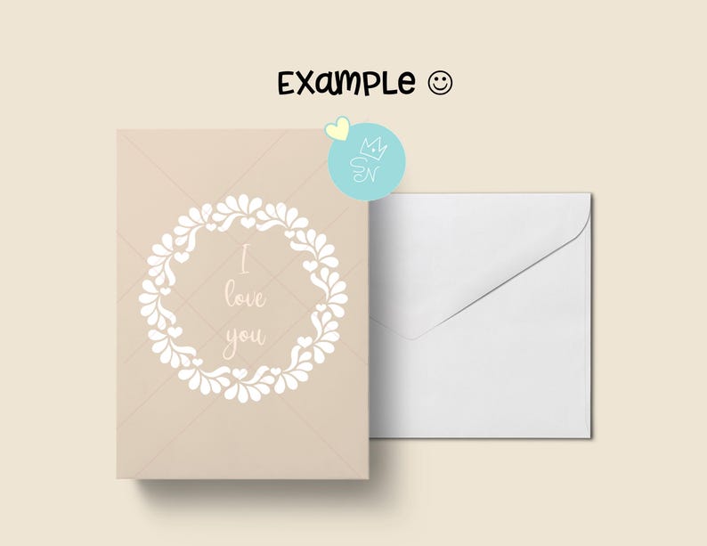 Puede incluir: Una tarjeta de felicitaci&oacute;n beige con una corona floral blanca y el texto "I love you". Una sobre blanco est&aacute; al lado de la tarjeta. La palabra "Example" est&aacute; escrita encima de la tarjeta.