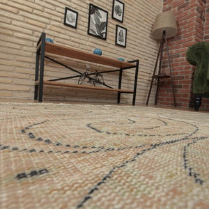 May include: A beige rug with a black and white geometric pattern. The rug is laid out on a wooden floor in front of a brick wall.