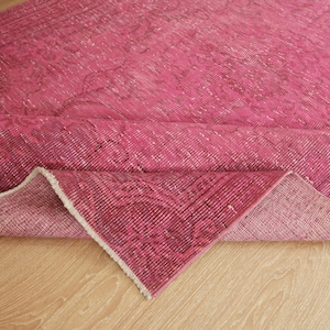 May include: A white ceramic mug with a black handle and the text "But First, Coffee" in a black, handwritten-style font. The mug is on a white surface.