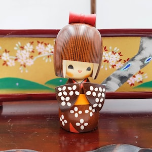 Kosode painted wooden Kokeshi doll with brown floral pattern