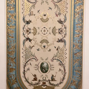 May include: A decorative print titled LA PEINTURE DÉCORATIVE en France DU XVIe AU XVIIIe SIÈCLE featuring a central cream panel with gold, blue, and multi-colored floral, animal, and human motifs, framed by a wide blue border with gold filigree.