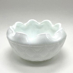 May include: White milk glass bowl with a scalloped rim and a diamond pattern on the bottom.