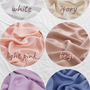 May include: A collection of fabric swatches in various colors, including white, ivory, light pink, beige, purple, and blue. Each color is displayed in a circular shape with the color name written on it.