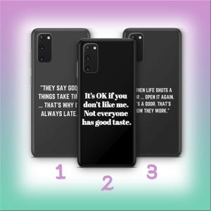 May include: Three black phone cases with white text. The center case reads "It's OK if you don't like me. Not everyone has good taste." The other cases have different quotes. The background is a gradient of purple and green.