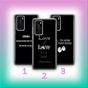 Puede incluir: Tres fundas negras para teléfono con texto blanco. Una funda dice "VODKA" y una cita. Otra dice "Love LAW It's your choice...". La tercera dice "...I'M HIDING STUPID PEOPLE" con ojos de dibujos animados.