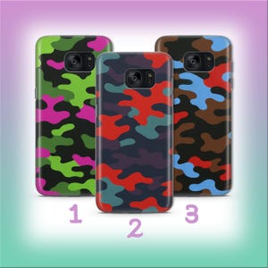 May include: Three phone cases with camouflage patterns. The first case is green, black, and pink. The second case is navy, red, and teal. The third case is brown, blue, and tan. Numbers 1, 2, and 3 are below each case.