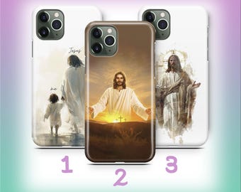 May include: Three phone cases with religious imagery. One case features Jesus with a child, another shows Jesus with outstretched arms against a sunset, and the third depicts Jesus with a halo. The cases are white and brown.