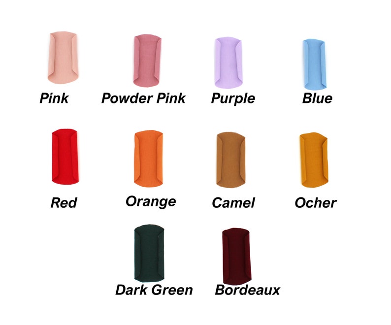May include: A collection of ten fabric samples in various colors, including pink, powder pink, purple, blue, red, orange, camel, ocher, dark green, and bordeaux. Each sample is labeled with its respective color name in a bold, sans-serif font.
