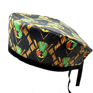 May include: A black scrub hat with a geometric pattern in yellow, green, and red. The hat has a black elastic band and ties.