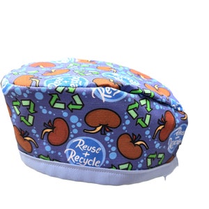 May include: A blue and white scrub hat with a pattern of brown kidneys, green recycle arrows, and blue bubbles. The hat has a white band with the text "Reuse + Recycle" in white.