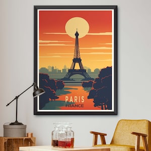 May include: A vintage-style poster featuring a silhouette of the Eiffel Tower in Paris, France. The poster has a sunset background with a large orange sun and a dark blue river flowing through the scene. The text "Paris, France" is printed at the bottom of the poster.