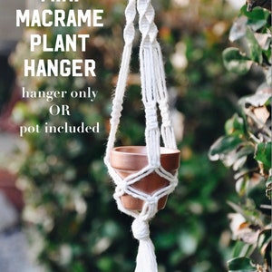 May include: White macrame plant hanger with a small terracotta pot. The text "MINI MACRAME PLANT HANGER hanger only OR pot included" is visible in the image.