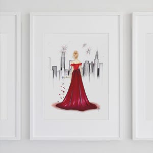 May include: Illustration of a woman in a red off-the-shoulder gown, holding a blue flower, with a cityscape backdrop. The artwork is framed in a white border, with a minimalist style. The artwork is a print.