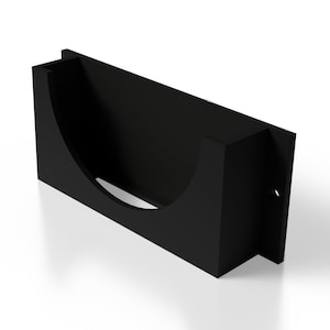 May include: A black, rectangular wall-mounted holder with a curved interior. The holder has a semi-circular cutout on the front and a small hole on the side. The design is simple and modern, suitable for various uses.