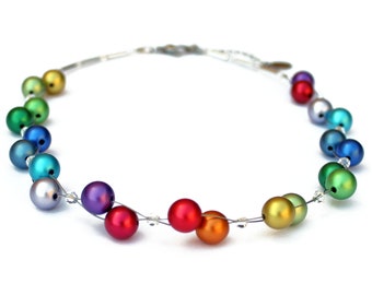 May include: A rainbow colored beaded necklace with silver wire and clear crystal accents.