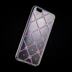 May include: A clear phone case with a diamond-like pattern in shades of purple, pink, and blue.
