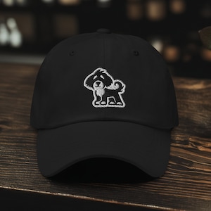 May include: Black baseball cap with a white embroidered image of a dog on the front.
