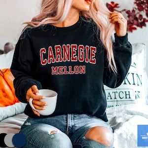 May include: Black sweatshirt with the text "Carnegie Mellon" in red.