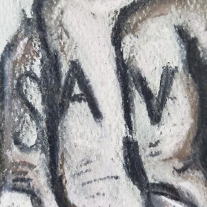May include: A close-up of a black and white drawing of an elephant's trunk with the word "SAV" written on it.