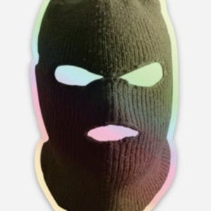 May include: A green ski mask with eye and mouth holes. The mask has a holographic effect with rainbow colors.